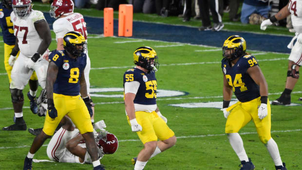 Jan 1, 2024; Pasadena, CA, USA; Michigan Wolverines defensive lineman Mason Graham (55) celebrates tackling Alabama Crimson Tide running back Jase McClellan (2) for a loss in overtime at the Rose Bowl. Left is Michigan Wolverines defensive end Derrick Moore (8), right is Michigan Wolverines defensive lineman Kris Jenkins (94).